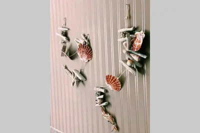 a wall with a bunch of birds on it at Cute Little House with a White Picket Fence in Burgas City