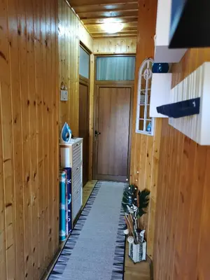 a hallway with wood paneled walls and a door at The Old House in Nesebar