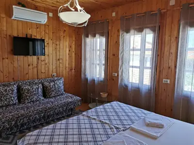 a living room with a couch and a tv at The Old House in Nesebar