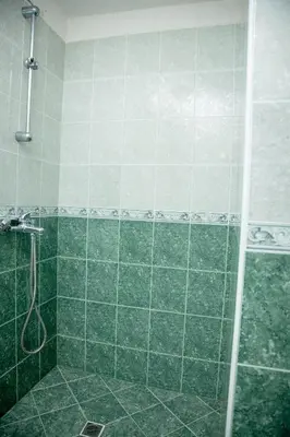 a bathroom with a shower with green tile at Villa Beni - 4 Bedroom Private House by Flаt Manаger in Lozenets