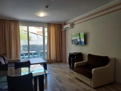 a living room with a couch and a chair and a table at Admiral Plaza Premium Apartments in Sunny Beach