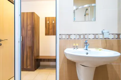 a bathroom with a sink and a mirror and a shower at Admiral Plaza Premium Apartments in Sunny Beach