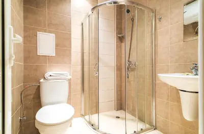 a bathroom with a shower and a toilet and a sink at Admiral Plaza Premium Apartments in Sunny Beach