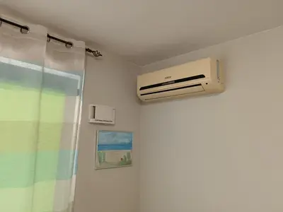 a bathroom with a air conditioner on the wall at Byala-apartment-valmira in Byala