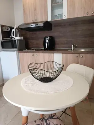 a white table with a bowl on top of it at Megi Apartments, Nesebar sity in Nesebar