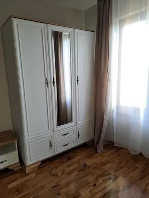 a white cabinet in a room with a window at Megi Apartments, Nesebar sity in Nesebar