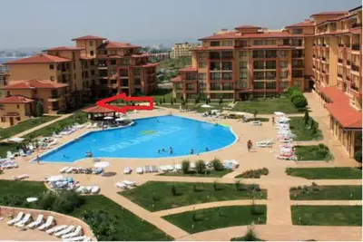 a large swimming pool in a resort with buildings at Bright Studio with Parking & Pool in Sveti Vlas