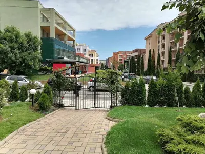 a gate in the middle of a city with buildings at Cozy studio with Pool in Sunny Beach in Sunny Beach