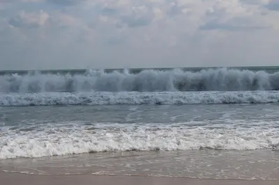 two waves in the ocean with foam on the shore at Villa Denta in Nesebar