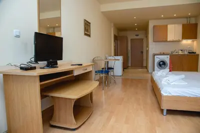 a room with a desk with a television and a bed at Studio with a balcony near the centre of Sunny Beach by Flаt Manаger in Sunny Beach