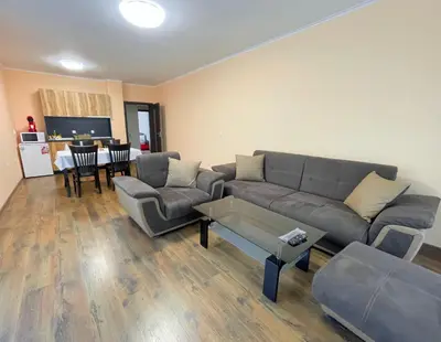 a living room with a couch and a table at Long Sunny Holiday in Shkorpilovtsi