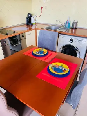 a kitchen with a table with two plates on it at Апартамент Морски Изглед in Burgas City