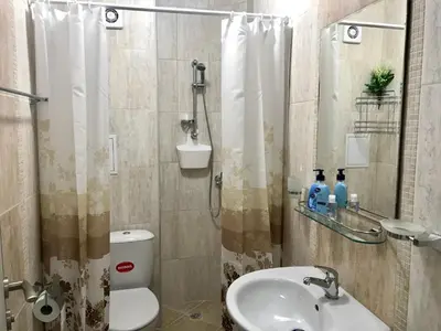 a bathroom with a shower and a toilet and a sink at Panorama beach Obzor in Obzor