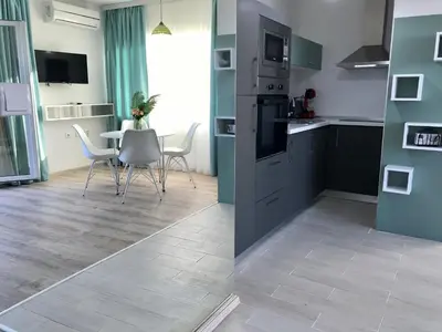 a kitchen and dining room with a table and chairs at Panorama beach Obzor in Obzor