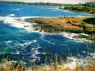 a body of water with waves on a rocky shore at Villa Mareli in Tsarevo