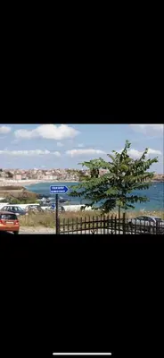 a tree on a fence with a street sign at sea ​​view apartment Sozopol in Sozopol