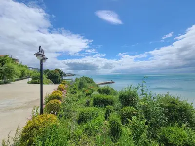 a street light next to a beach with the ocean at Prestige Fort Aparthotel - Private apartment-BSR in Sveti Vlas