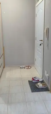 a hallway with shoes on the floor next to a door at Sunny Fort Private Apartment in Sunny Beach
