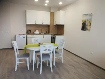 a kitchen and dining room with a table and chairs at Donchevi Apartments in Primorsko