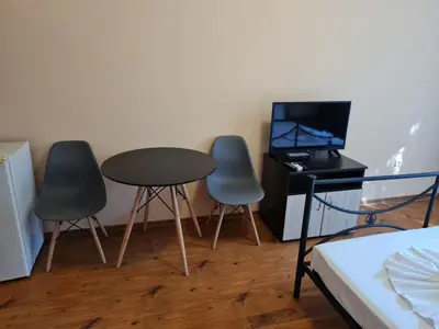 a room with three chairs and a table and a television at MitProt Panorama Bay 2 ap 30 in Sveti Vlas