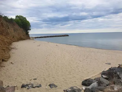 a sandy beach with rocks and the water at MitProt Panorama Bay 2 ap 30 in Sveti Vlas