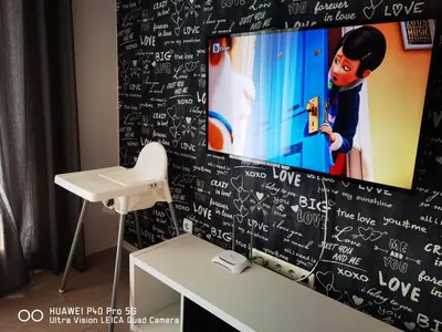 a tv on a wall with writing on it at Apartment Beach Kavatsi in Sozopol