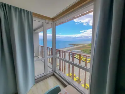 a room with a large window with a view of the ocean at Paradiso Aparthotel - Private apartment-BSR-1 in Nesebar