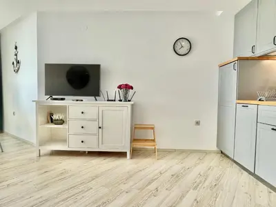 a living room with a tv on a white wall at Paradiso Aparthotel - Private apartment-BSR-1 in Nesebar