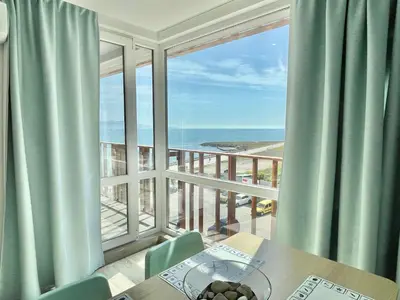 a dining room with a view of the ocean at Paradiso Aparthotel - Private apartment-BSR-1 in Nesebar