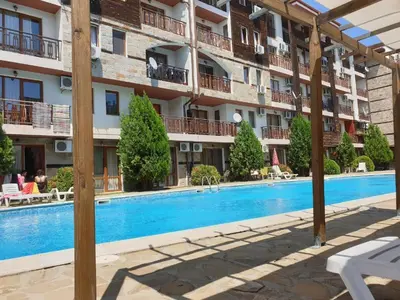 a hotel with a swimming pool in front of a building at MitProt Panorama Bay 2 luks apartment ap.73 in Sveti Vlas