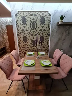 a dining room table with pink chairs around it at MitProt Panorama Bay 2 luks apartment ap.73 in Sveti Vlas