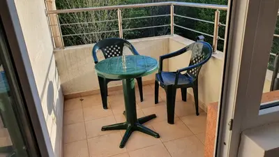 a table and two chairs on a balcony at Pomorie Beach Resort in Pomorie