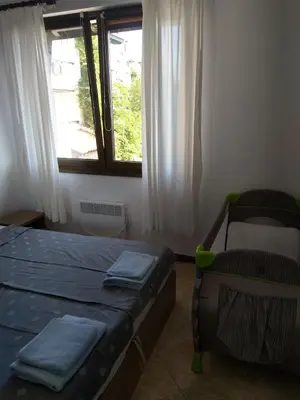 a bedroom with two beds and a window at Apartment in the picturesque Oasis Resort & Spa in Lozenets