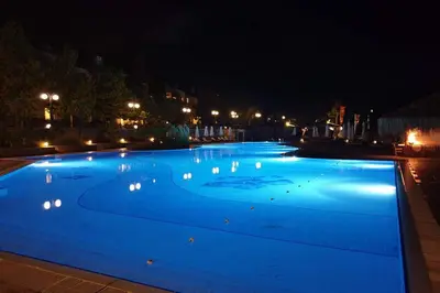 a large swimming pool lit up at night at Apartment in the picturesque Oasis Resort & Spa in Lozenets