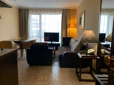 a living room with a couch and a tv at Royal Beach Apartament Hotel in Sunny Beach