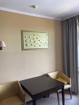 a room with a table and two chairs and a painting at Royal Beach Apartament Hotel in Sunny Beach