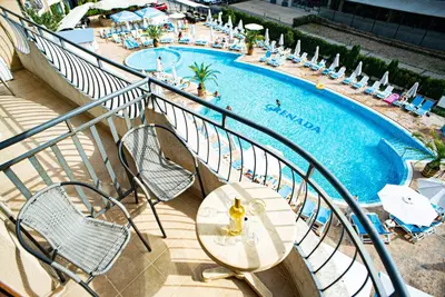 a view of a swimming pool with chairs and a table at Grenada Apartaments in Sunny Beach