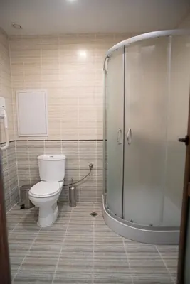 a bathroom with a toilet and a glass shower at Grenada Apartaments in Sunny Beach