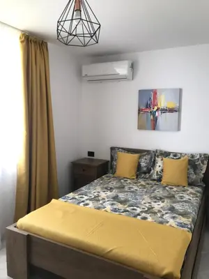a bedroom with a bed with yellow pillows at Вила TIMeS in Kiten