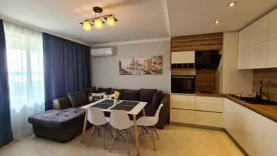 a kitchen and living room with a table and a couch at Apartment on the beach Ravda in Ravda