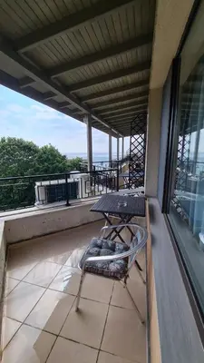 a balcony with a table and a chair on a roof at Apartment on the beach Ravda in Ravda