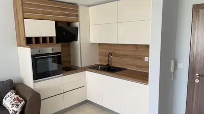 a kitchen with white cabinets and a sink at Apartment on the beach Ravda in Ravda