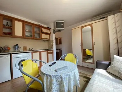 a kitchen with a table and chairs in a room at ANITA A3 Cosy Studio SUNNY BEACH in Sunny Beach