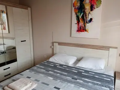 a bedroom with a bed and a painting on the wall at 3 стаен апартамент идеален център Варна in Varna City