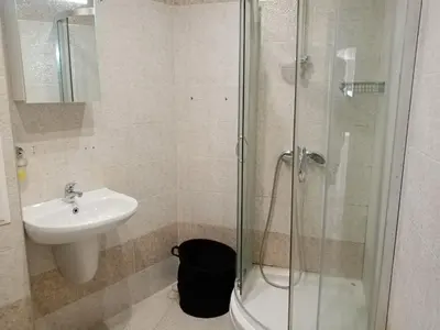 a bathroom with a sink and a glass shower at 3 стаен апартамент идеален център Варна in Varna City