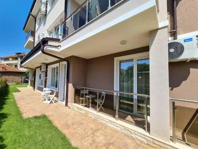 a balcony of a house with a table and chairs at Villa Yanevi in Ravda