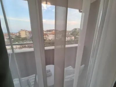 a view of a balcony with white chairs and a window at Villa Yanevi in Ravda