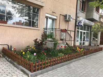 a flower garden in front of a building at Ssenyange Guest House in Varna City