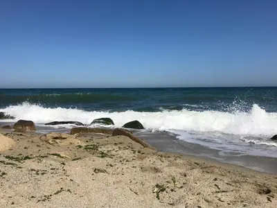 a beach with waves crashing on the shore at Ssenyange Guest House in Varna City