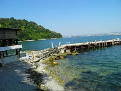 a dock in the water next to a body of water at Ssenyange Guest House in Varna City